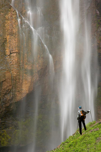 Man and waterfall by Don Paulson