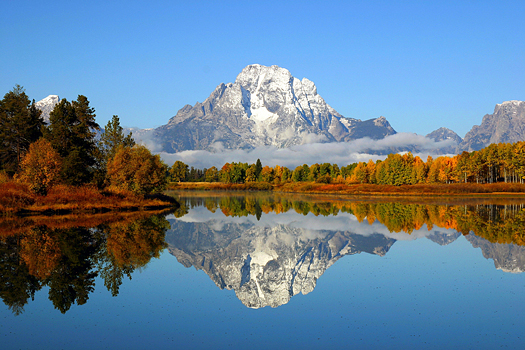 Reflection of mountain range in a lake at Grand Teton National Park