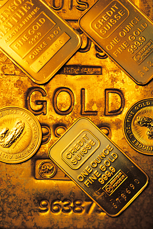 A gold ingot with several gold coins on top of it