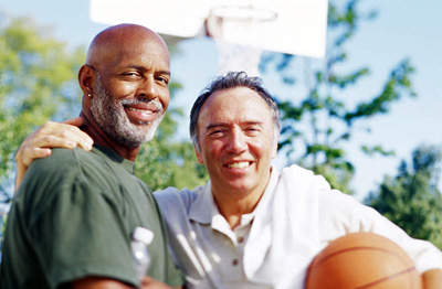 Two middle aged men with a basketball